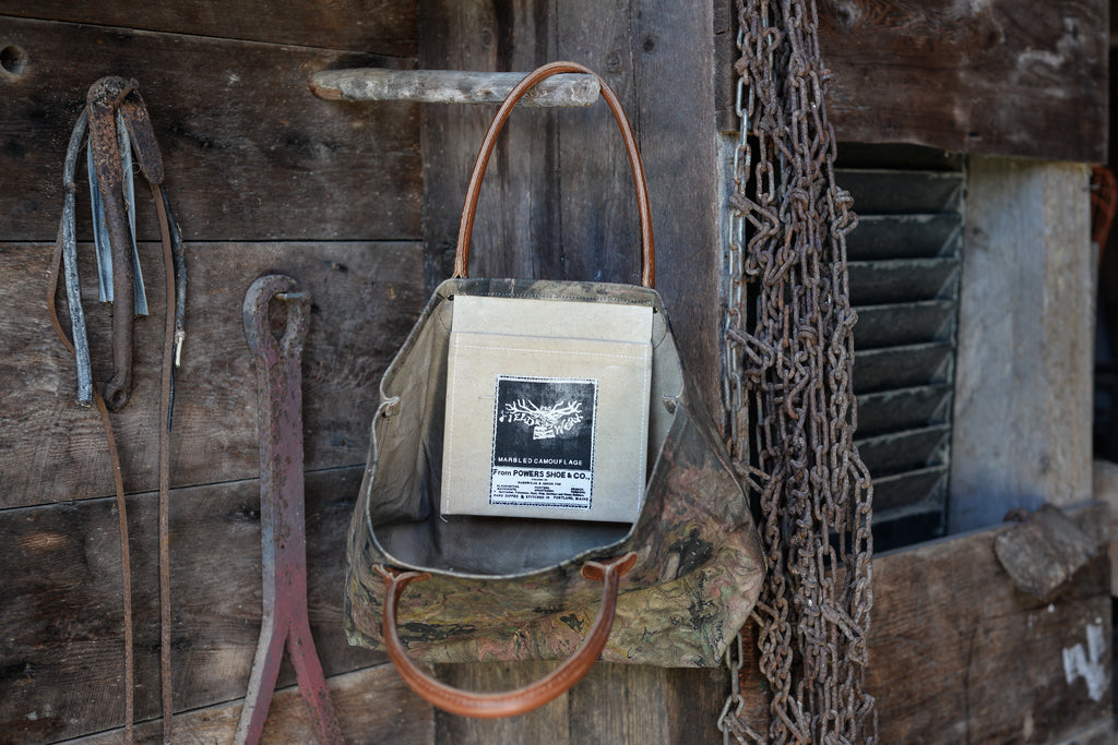 Vintage-style bag with a leather handle on a rustic wooden background