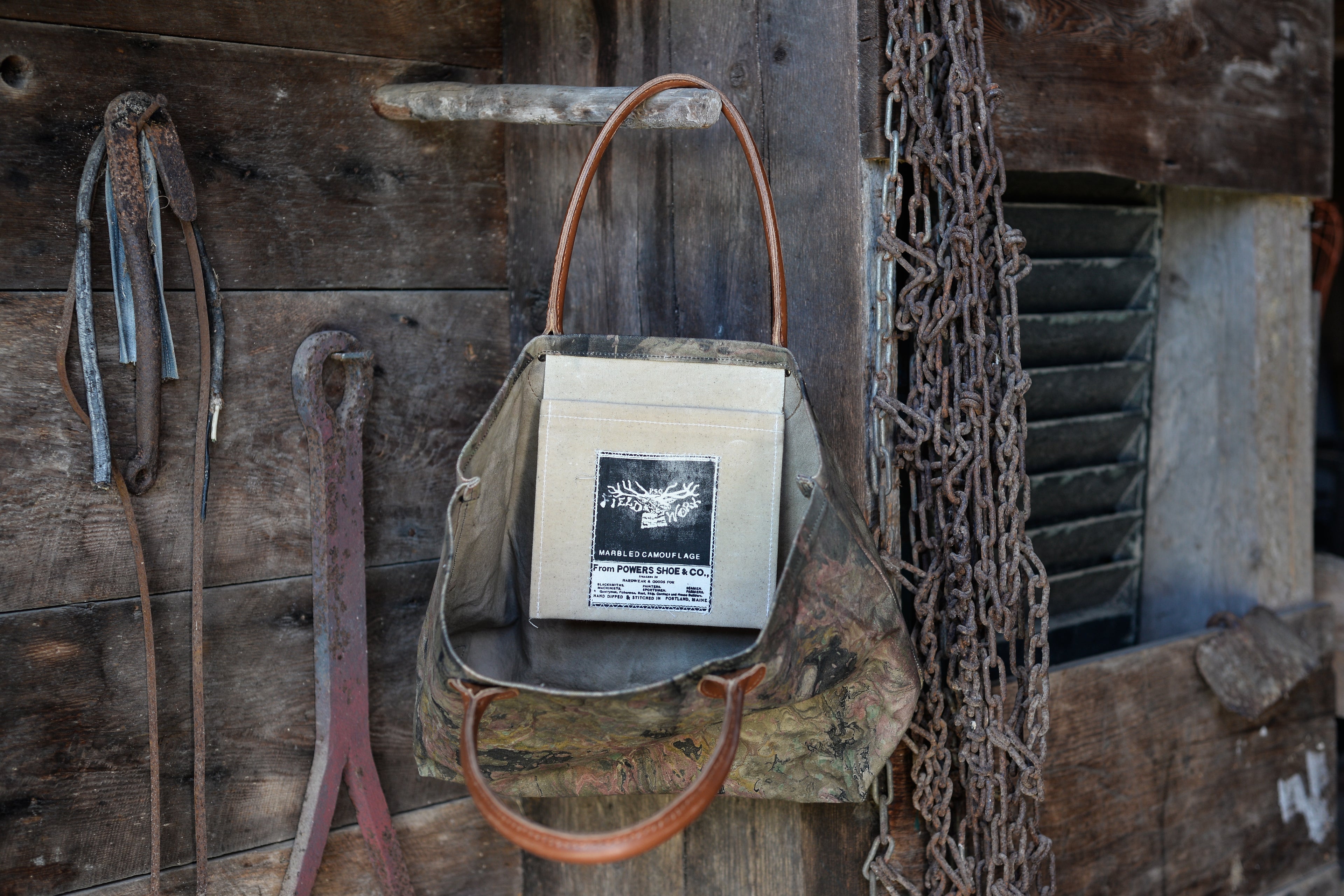 Vintage-style bag with a leather handle on a rustic wooden background